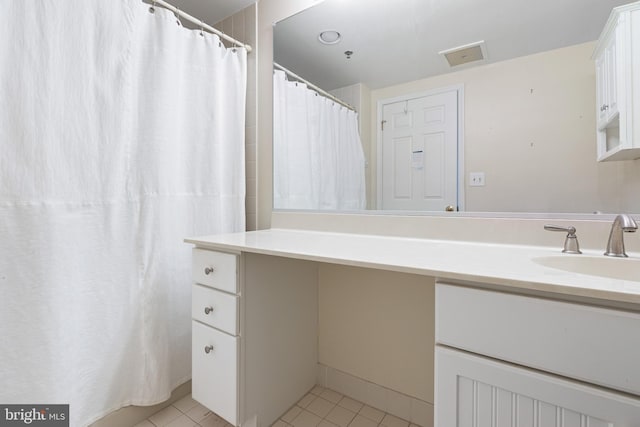 bathroom with vanity and tile patterned flooring