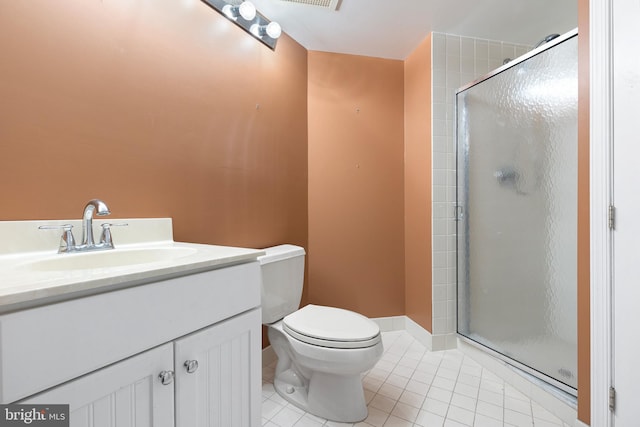 bathroom featuring toilet, tile patterned flooring, vanity, and a shower with door