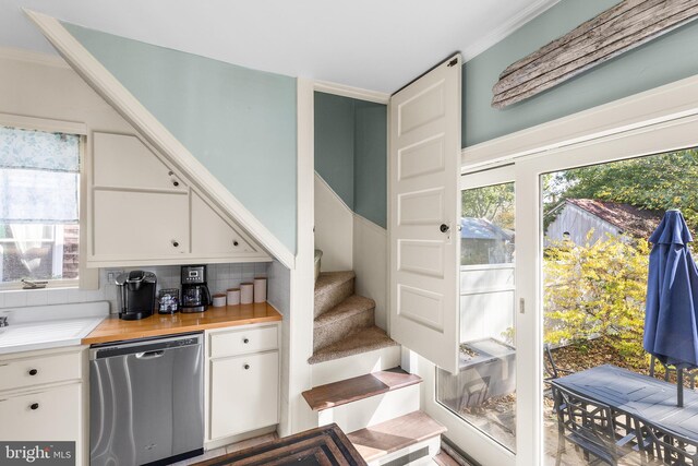 interior space featuring ornamental molding and a wealth of natural light