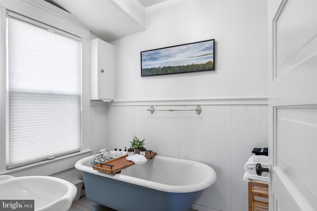 bathroom with wood walls and a washtub