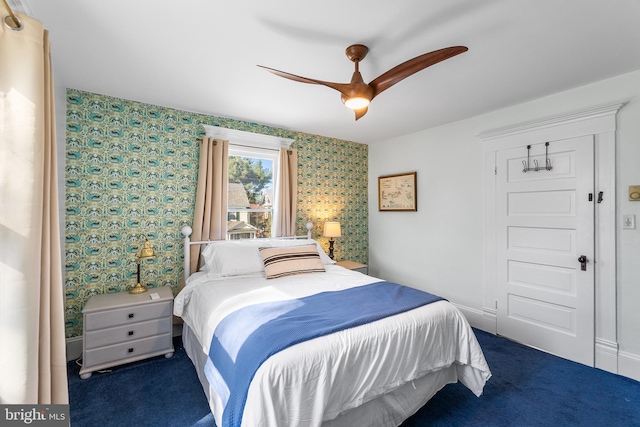 bedroom featuring dark carpet and ceiling fan