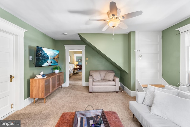 living room featuring light colored carpet and ceiling fan