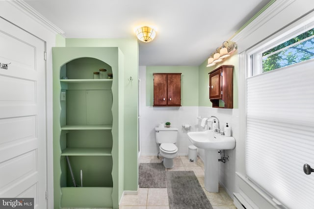 bathroom featuring toilet, tile walls, and tile patterned flooring