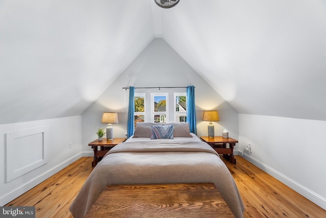 bedroom featuring lofted ceiling and wood-type flooring