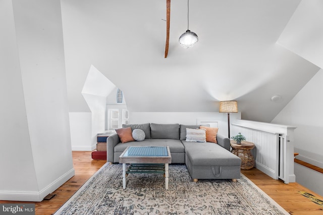 living room featuring lofted ceiling and light wood-type flooring