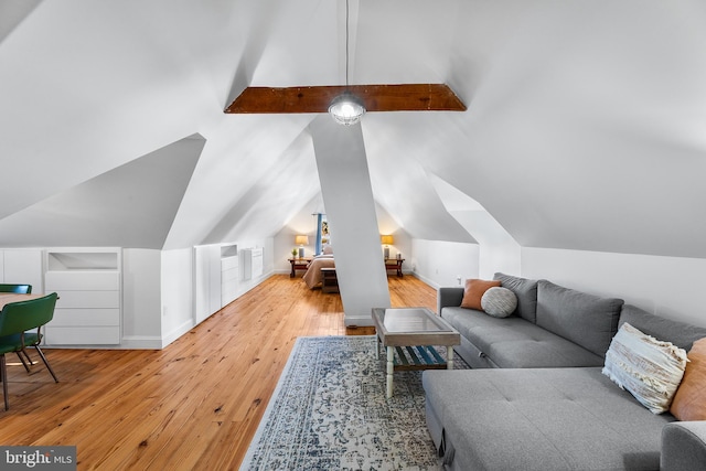 living room featuring vaulted ceiling with beams and light hardwood / wood-style floors