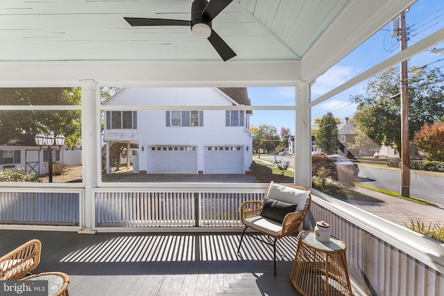 sunroom with ceiling fan and lofted ceiling