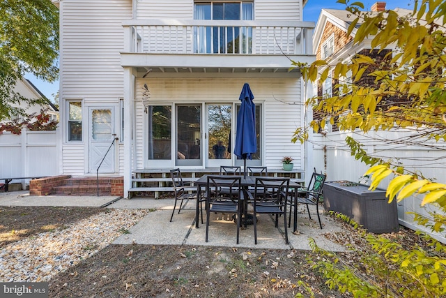 view of patio with cooling unit and a balcony