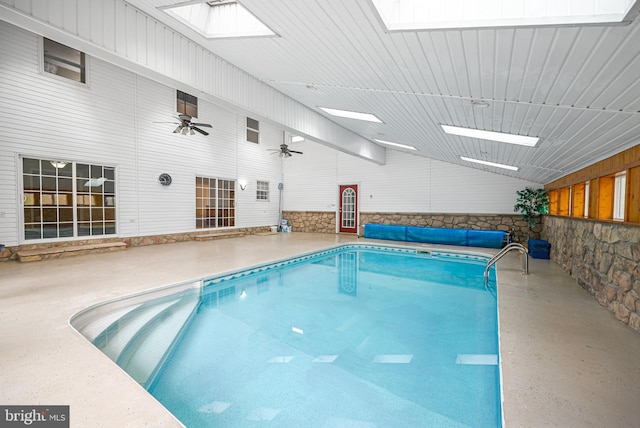 view of pool with a skylight and ceiling fan