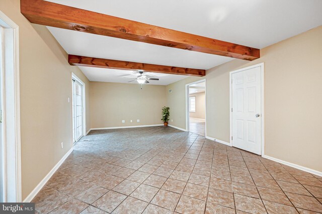 tiled spare room with beamed ceiling and ceiling fan