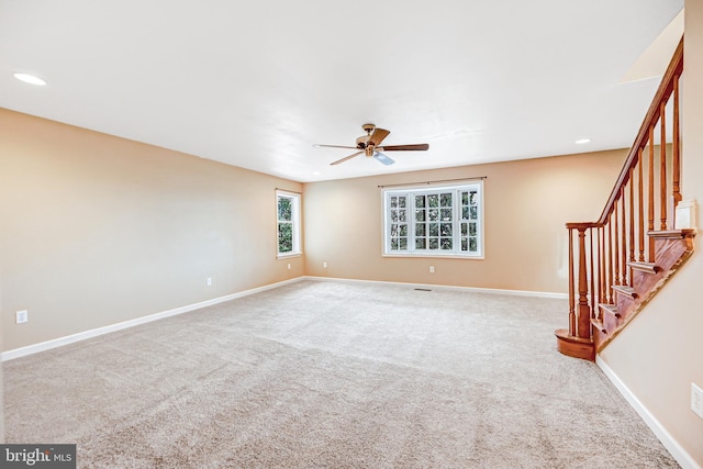 unfurnished living room with ceiling fan and light carpet