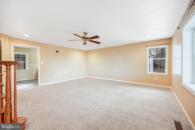 carpeted spare room with ceiling fan