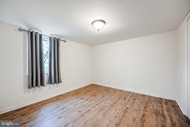 spare room with hardwood / wood-style flooring