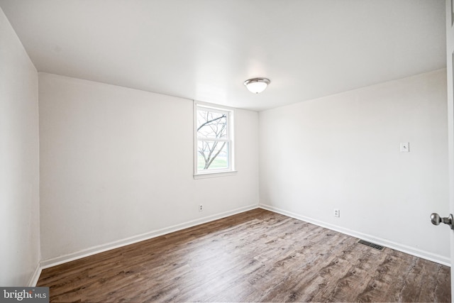 spare room with wood-type flooring