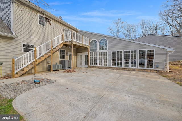 back of house with central AC unit, a patio area, a deck, and french doors