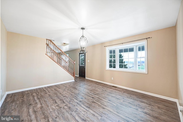 interior space featuring hardwood / wood-style floors and a chandelier