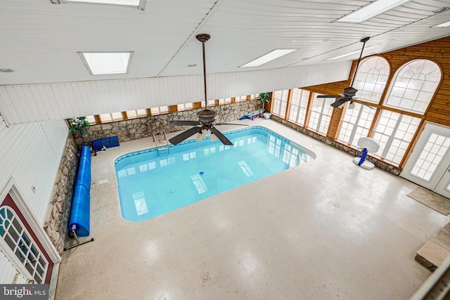 view of swimming pool featuring a skylight and ceiling fan