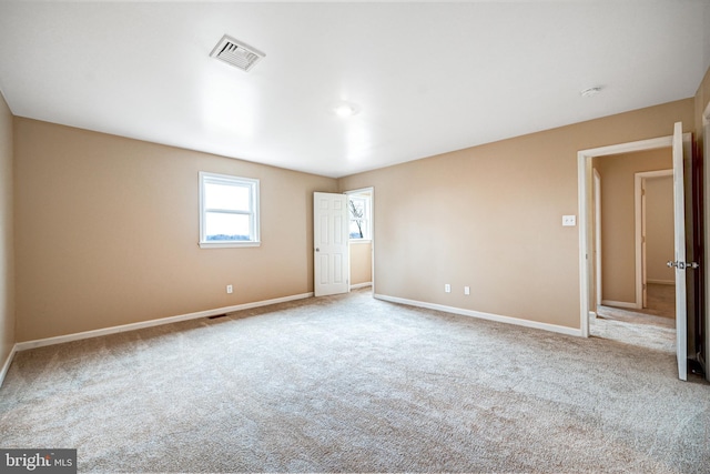 spare room featuring light colored carpet