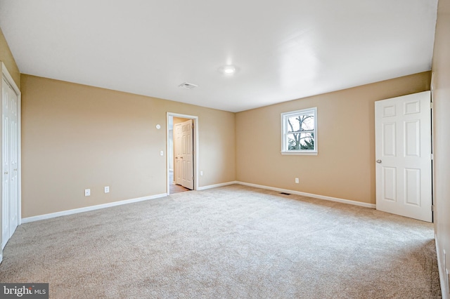 unfurnished bedroom with light colored carpet