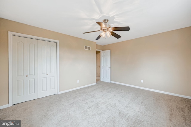 unfurnished bedroom with carpet flooring, ceiling fan, and a closet