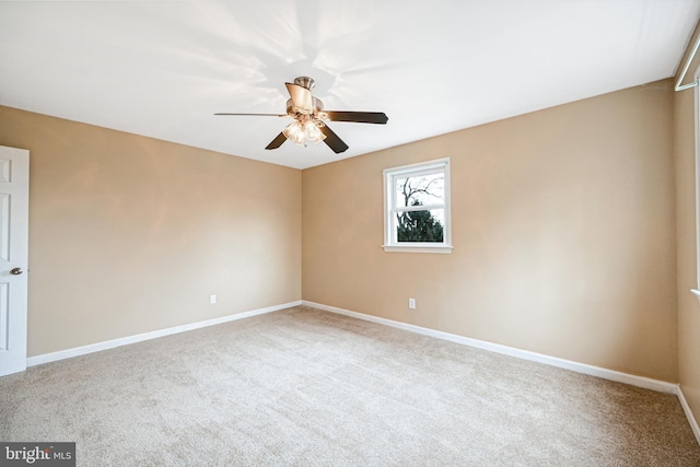 unfurnished room featuring ceiling fan and carpet