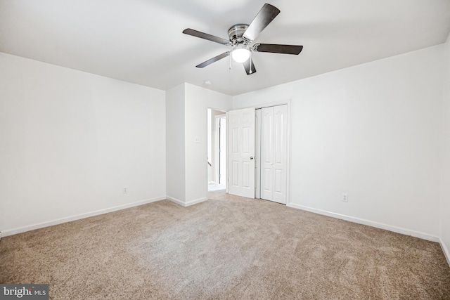 unfurnished bedroom featuring ceiling fan, carpet floors, and a closet