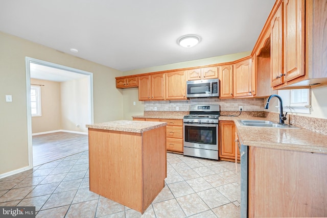 kitchen with tasteful backsplash, sink, light tile patterned floors, and appliances with stainless steel finishes