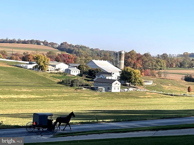 view of community with a yard and a rural view