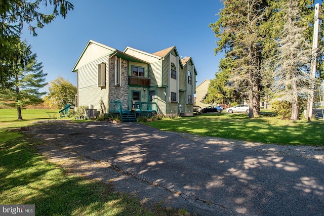 view of front of home featuring central air condition unit and a front lawn