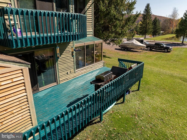 wooden deck featuring a yard