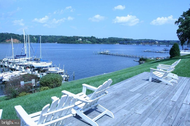 dock area featuring a water view and a lawn