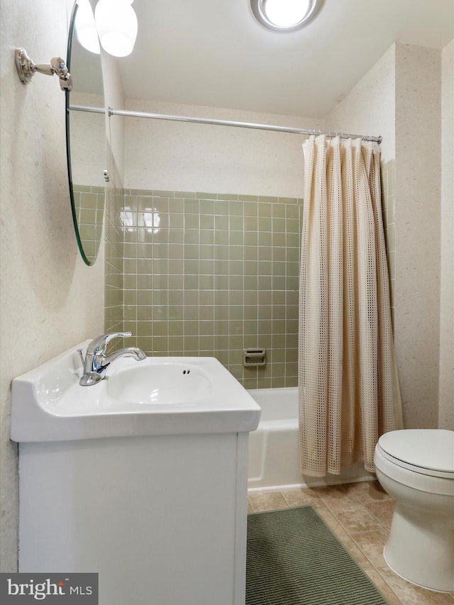 full bathroom with vanity, shower / bath combo with shower curtain, toilet, and tile patterned flooring