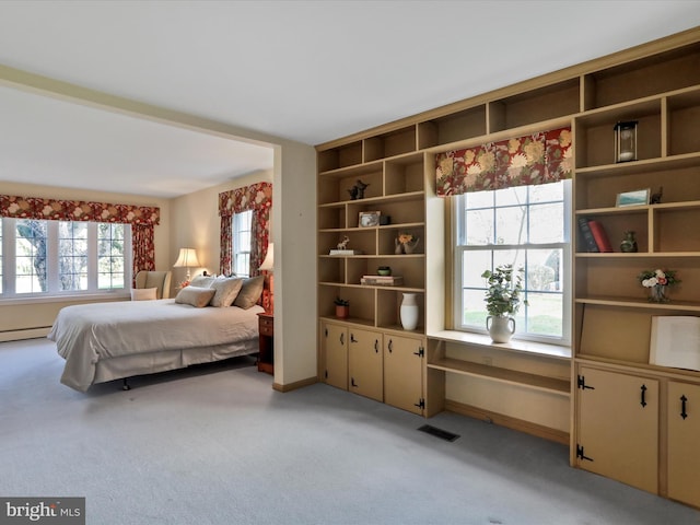 carpeted bedroom featuring a baseboard radiator