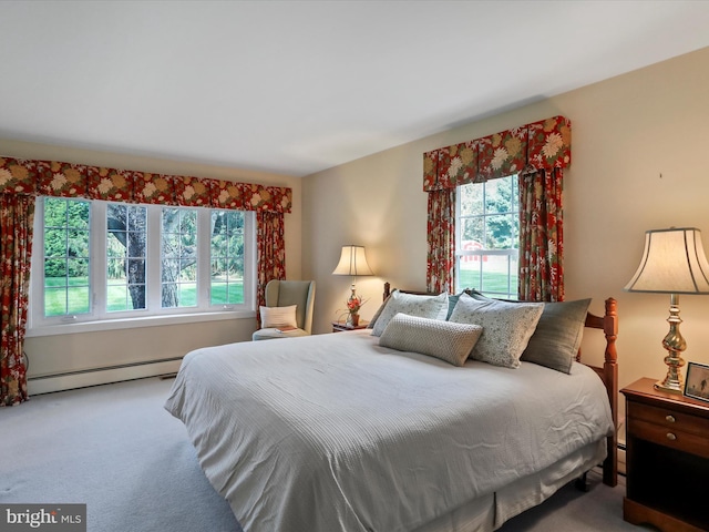 carpeted bedroom featuring baseboard heating