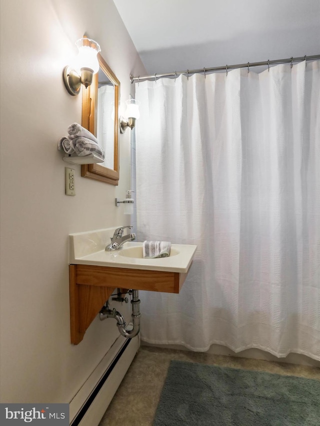 bathroom with baseboard heating and a shower with curtain