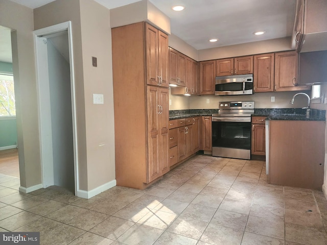 kitchen featuring appliances with stainless steel finishes and light tile patterned flooring