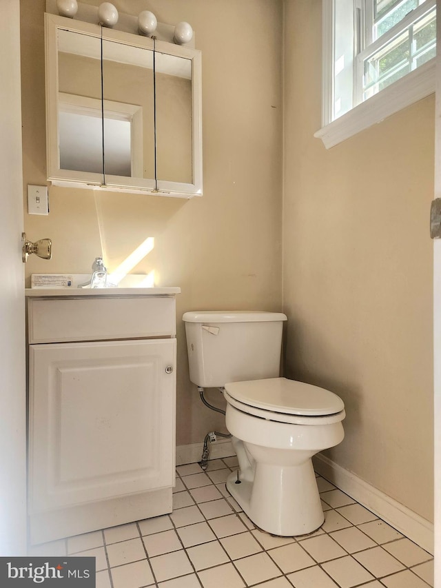 bathroom featuring vanity, toilet, and tile patterned floors