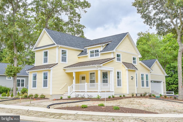 view of front of property featuring a porch and a garage