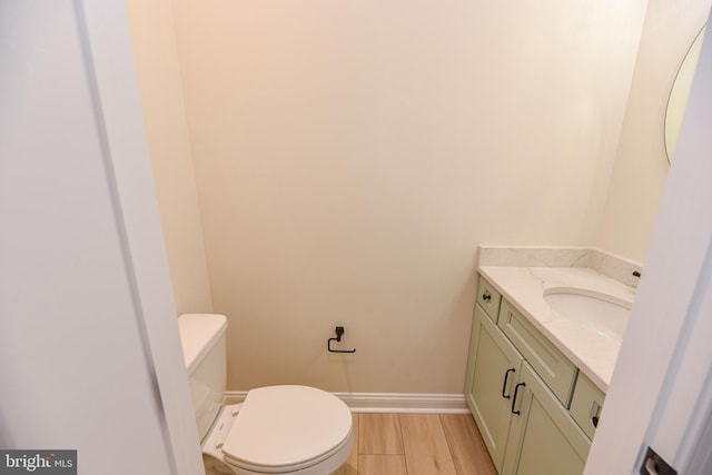 bathroom featuring vanity, toilet, and wood-type flooring