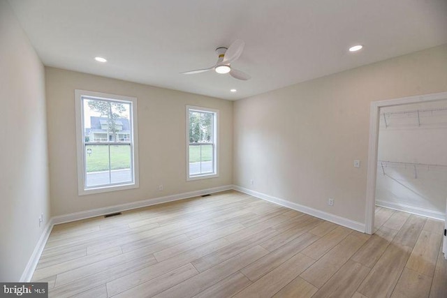 empty room featuring ceiling fan and light wood-type flooring