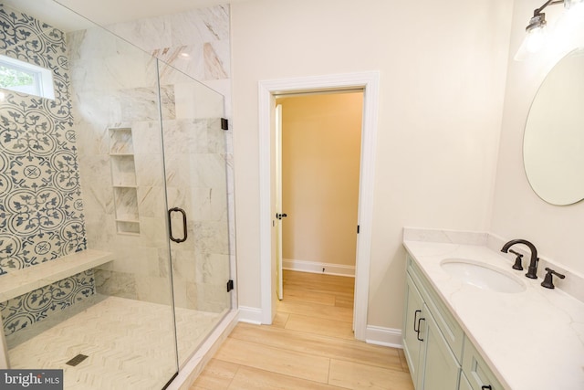 bathroom with vanity, walk in shower, and wood-type flooring