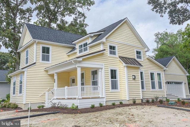 view of front of house featuring a garage and a porch