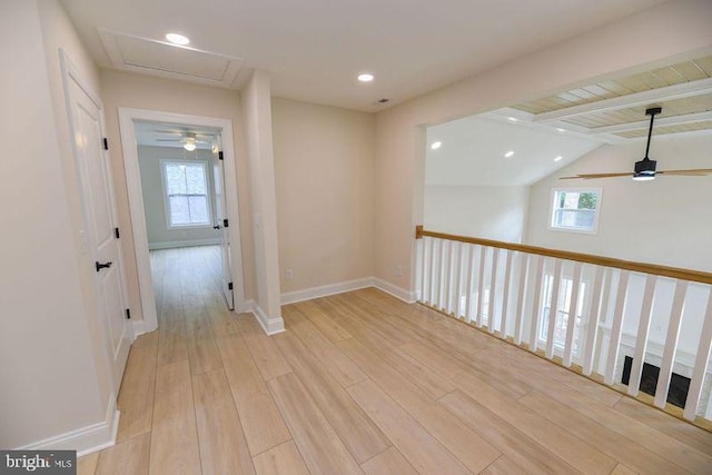 corridor with vaulted ceiling with beams, light hardwood / wood-style flooring, and plenty of natural light