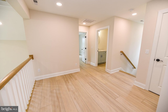 hallway with light hardwood / wood-style floors