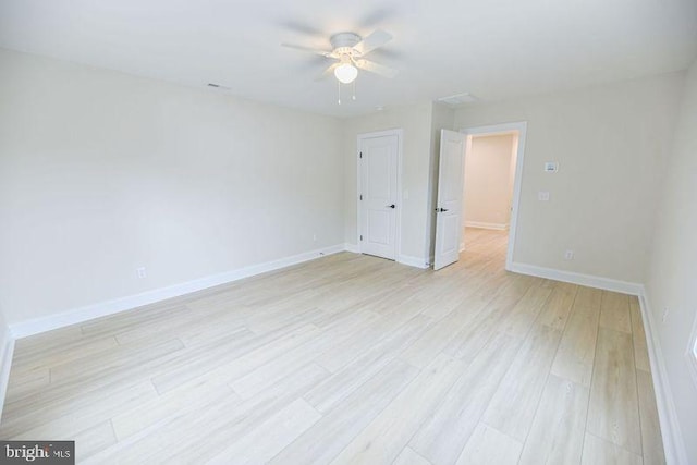 empty room featuring light hardwood / wood-style flooring and ceiling fan