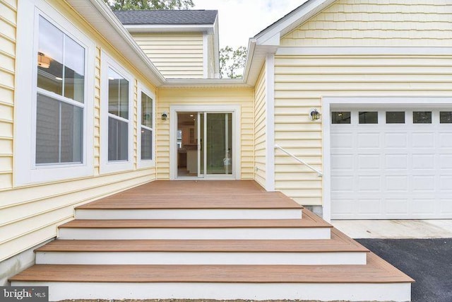 entrance to property with a deck and a garage