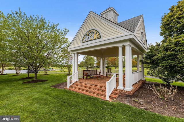 exterior space featuring a porch and a yard