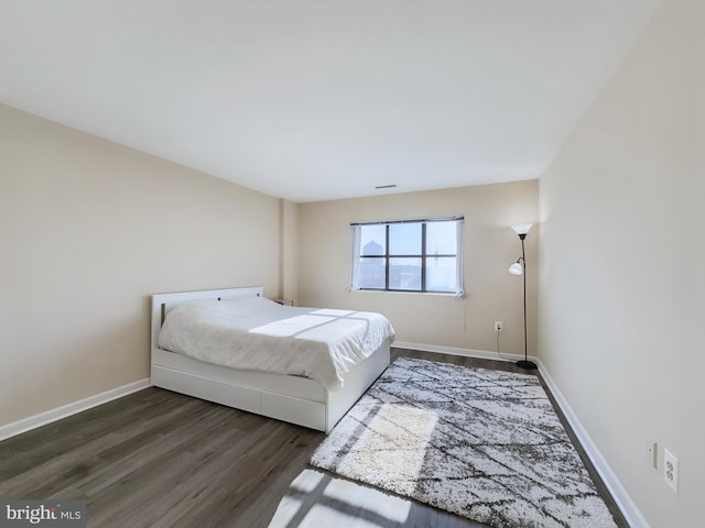 unfurnished bedroom with dark hardwood / wood-style floors