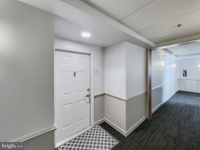 foyer with dark colored carpet