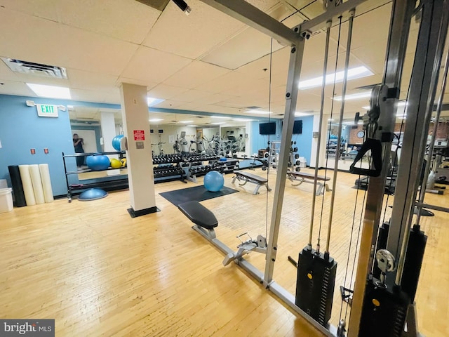 exercise room with hardwood / wood-style floors